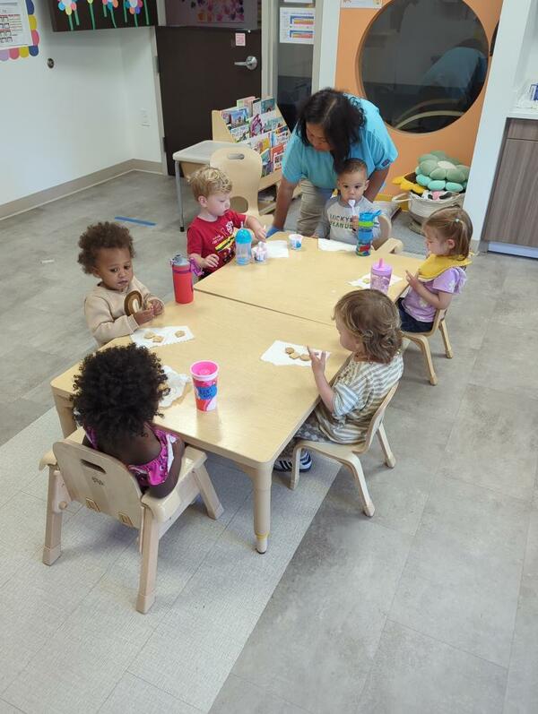 Spark Preschool Students Sitting at a table eating at snack time